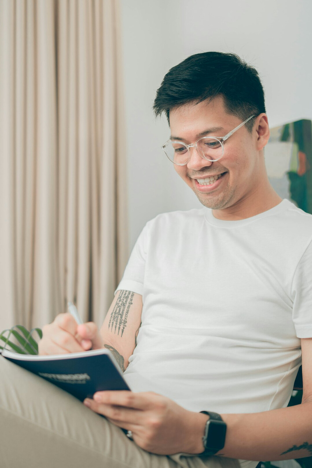 man writing in journal